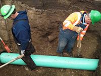 Maintenance Workers Working on a Pipe Underground